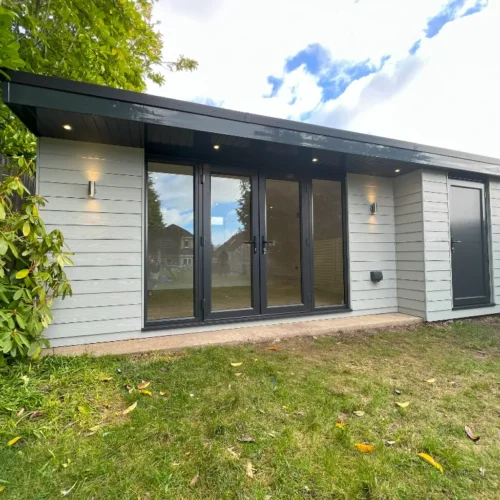 Garden Room with White Cladding in the back of a Garden